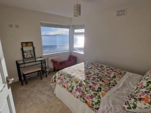 a bedroom with a bed and a view of the ocean at Beach House in Duncannon