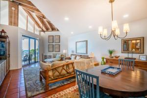 a dining room and living room with a dining table at Casa Pap Del Mar in Key West