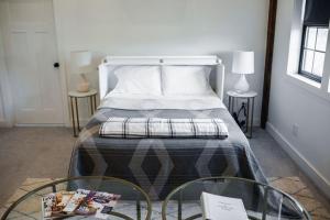 1 dormitorio con cama y mesa de cristal con ventana en A Suite with a View + Wine, en Mount Airy