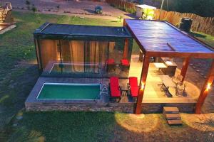 a small house with a pool in the backyard at Sojourn Cabins in Anomabu
