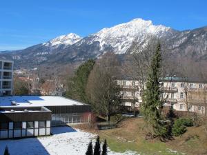 a building with snow covered mountains in the background at Apartment Panorama in Bad Reichenhall
