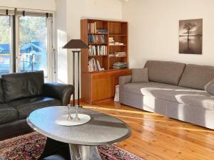 a living room with a couch and a table at Holiday home Åhus in Åhus