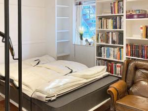 a bed in a room with a book shelf at 6 person holiday home in Åhus-By Traum in Åhus