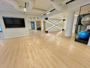 a large room with wooden floors and a flat screen tv at Exquisite Condo By Exhibition Place Downtown Toronto in Toronto