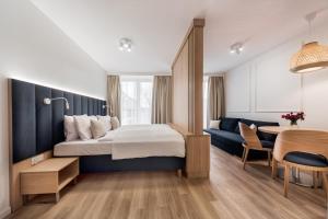 a hotel room with a bed and a table at Aurum Aparthotel - Nowe Apartamenty blisko Plaży - Neue Appartements in Strandnähe in Świnoujście