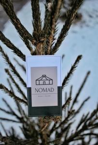 a sign on a christmas tree at Hotel NOMAD in Aktobe