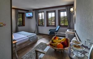 a hotel room with a bed and a tray of fruit at Manoleva House in Melnik