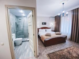 a bedroom with a bed and a bathroom with a shower at Aspar Boutique Hotel in Yerevan +138 photos