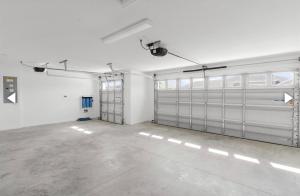 a garage with metal garage doors in a room at Relaxing, Golf, Pools, Hiking, events in Wildwood