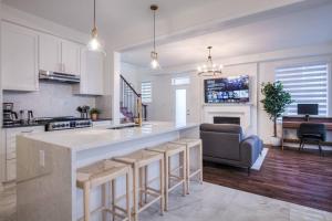 a kitchen and living room with a large counter top at Modern Comforts and Spacious Living 4B/3.5 Bath in Pickering