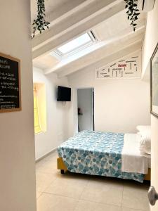 a bedroom with a bed and a skylight at Pink House Garden in Monterosso al Mare