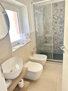 a bathroom with a toilet and a sink and a shower at Pink House Garden in Monterosso al Mare