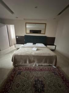 a bedroom with a large bed and a rug at Hotel Pousada Irmaos Freyhardt in Rio de Janeiro