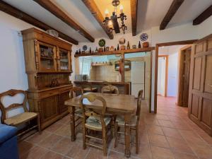 a kitchen with a wooden table and a dining room at Vivienda Vacacional VELEFIQUE in Velefique