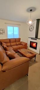 a living room with a couch and a fireplace at El Zarzal de Segura in Segura de León