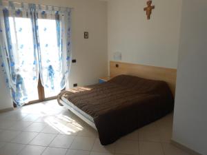 Un pat sau paturi într-o cameră la Appartamenti Elisa