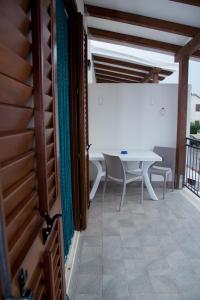a room with a table and chairs on a balcony at Casa Diamante in San Vito lo Capo