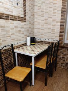a table and chairs in a room with a checkerboard table at TeRoom in Ternopil +19 photos