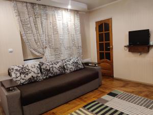 a living room with a couch in front of a window at TeRoom in Ternopil
