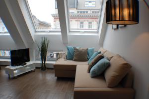 a living room filled with furniture and a window at Alga Apartments am Westbahnhof in Vienna