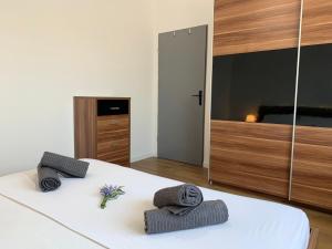 a bedroom with a bed with towels on it at LARUS apartment in Kastel Luksic