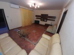 a living room with two white couches and a television at Principessa e ranocchio in Custonaci