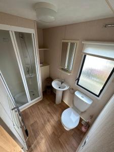 an overhead view of a bathroom with a toilet and a sink at No. 1 Family Caravan at Golden Gate Holiday Centre, Sleeps 6 in Abergele