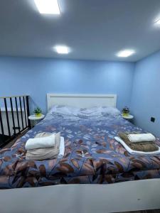 a bedroom with a large bed with pillows on it at Turquoise Apartment in Baku