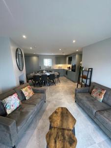 a living room with two couches and a table at Harbour view apartment in Annalong +27 photos