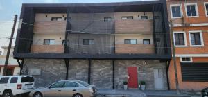 a building with a red door and a balcony at Loft 33 in Monterrey