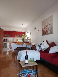 a living room with a couch and a table with a bottle of wine at Apartments K & K Dubrovnik in Dubrovnik