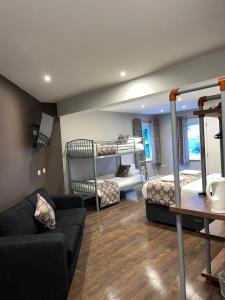 a living room with two bunk beds and a couch at The Vine Hotel Chapel st Leonards in Skegness