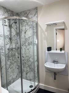 a bathroom with a shower and a sink at The Vine Hotel Chapel st Leonards in Skegness