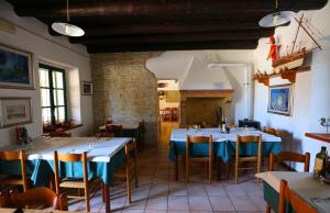 a restaurant with tables and chairs in a room at Corte Valesana in Lazise