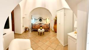 a bedroom with a bed in a white room at B&B Villa Maggi in Locorotondo
