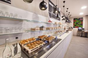 a bakery with a bunch of pastries and wine bottles at Bhotel in Lagonegro