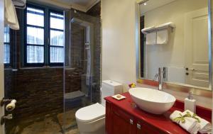 a bathroom with a sink and a toilet and a shower at Zagori Suites Luxury Residences in Vitsa +74 photos