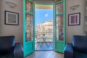 a room with a door open to a balcony at VICTOR HUGO - Modern and sunny, terrace, 2 baths in Nice