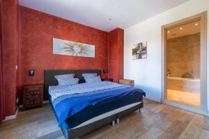 a bedroom with a bed and a red wall at VICTOR HUGO - Modern and sunny, terrace, 2 baths in Nice