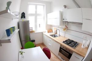 a small kitchen with white cabinets and a sink at Classic Apartment with Private Sauna in Old Town in Gdańsk