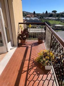 a balcony with three potted plants and a railing at Casa Viola vicino al mare by SMART-HOME in Vallecrosia +30 photos