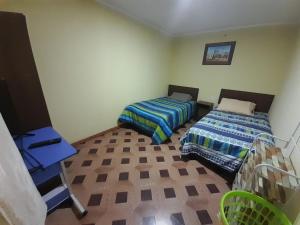 Cama o camas de una habitación en Hostal MIRAMAR En Pleno Centro de Pozo Almonte