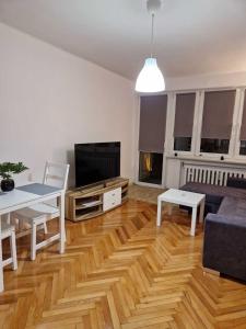 a living room with a couch and a table at Apartament w Centrum in Prudnik