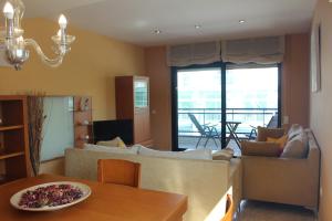 a living room with a couch and a table at Apartamento con Parking a 200m del mar in Tossa de Mar +27 photos