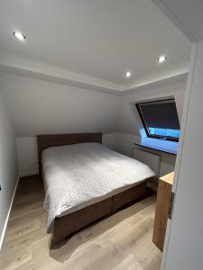a small bedroom with a bed and a window at Ferienwohnung Nella in Paderborn