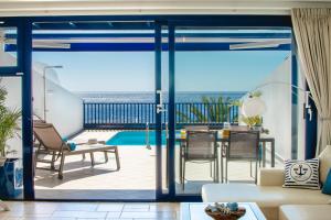 a living room with a view of the ocean at FRONTLINE VILLA 26, Modern Coastal Design with Amazing Views in Puerto Calero