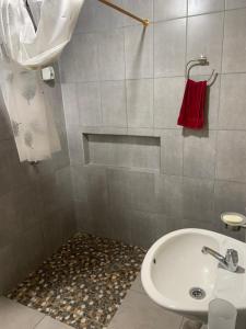 a bathroom with a white sink and a red towel at Playa Tortuga in Puerto Misahuallí +49 photos