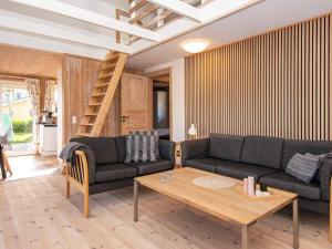 a living room with two couches and a coffee table at 8 person holiday home in Hejls in Hejls