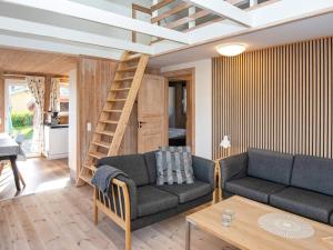 a living room with a couch and a staircase at 8 person holiday home in Hejls in Hejls