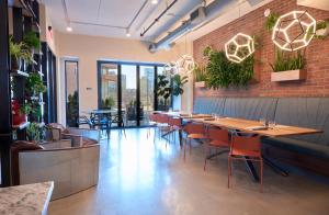 a restaurant with tables and chairs and a brick wall at The Maj Hotel in Philadelphia